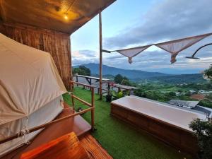 a room with a bath tub and a view of the mountains at ม่านเขาโฮมสเตย์ Mankhao Homestay in Ban Tai