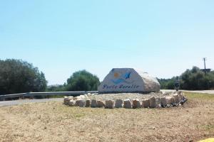 a large rock sitting on the side of a road at "Ruby Seadragon Holiday Home" a 80 m dal mare con giardino recintato P5584 in Villaputzu