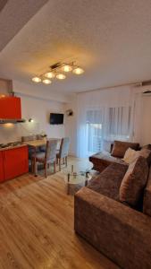 a living room with a couch and a table at Apartman SKY 4 in Brčko