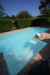 a swimming pool with blue water in a yard at Boho Suites Denia in Denia