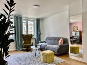 a living room with a couch and a chair at Art space at Old Town in Gdańsk