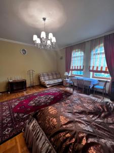 a living room with a couch and a table at Spacious rooms in peaceful Jelgava area in Jelgava