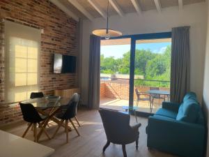 ein Wohnzimmer mit einem blauen Sofa und einem Tisch in der Unterkunft Alma Marina Apartamentos in Somo