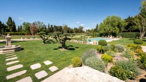 a garden with trees and a swimming pool at Mas Sourso in Eygalières