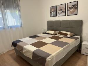 ein Schlafzimmer mit einem Bett mit zwei Kissen darauf in der Unterkunft Olive center apartment in Trebinje + 13 Fotos