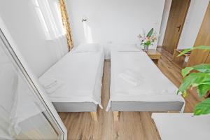 Łóżko lub łóżka w pokoju w obiekcie Dom Wczasowy Beskidy
