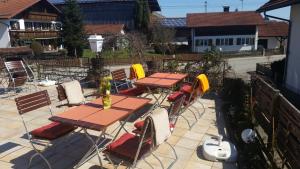 a group of tables and chairs on a patio at Ristorante Pizzeria Pension Taormina in Roßhaupten +15 photos
