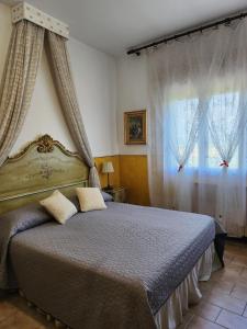 a bedroom with a bed and a window with curtains at Alloggi Adamo Venice in Oriago Di Mira