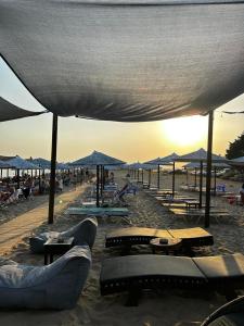a beach with chairs and tables and umbrellas at Earthly paradise Kariani in Karianí +10 photos