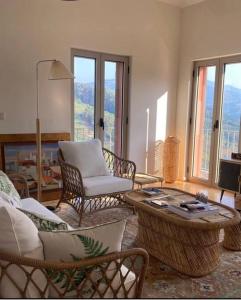 a living room with chairs and a coffee table at Outeiro Douro House in Mártir