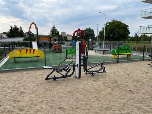 a playground in a park withspectacular equipment in the sand at Apartament Stogi in Gdańsk