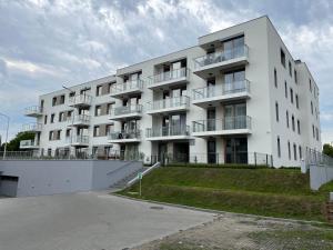 a white building with balconies on the side of it at Apartament Stogi in Gdańsk
