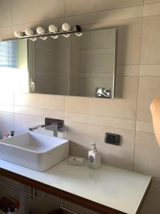 a bathroom with a white sink and a mirror at marefuori in Trapani