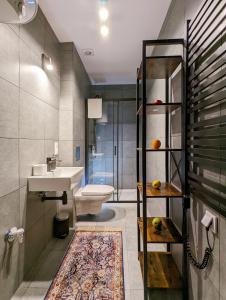 a bathroom with a sink and a toilet and a shower at Apartamenty Strzelecka 34 in Poznań