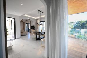 a living room and dining room with a dining table at ROYAL VIEW VILLAS in Skiathos