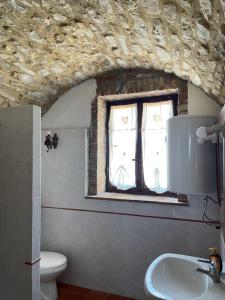 baño con lavabo y ventana en Castello di Selvole, en Vagliagli