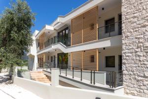 a house with wooden shutters on the balconies at Green Hill Thassos in Skala Potamias