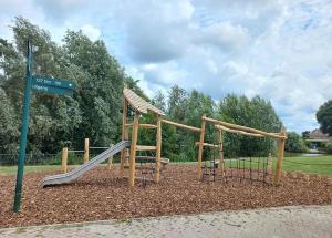 a playground with a slide in a park at Het Yorritje - tiny house nabij kust in Dirkshorn