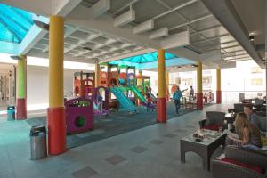 a group of people sitting in a playground at Apartment Sahala in Tivat