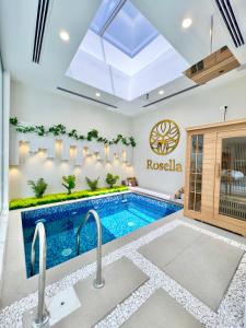 a swimming pool in a living room with a swimming poolvisor at Rosella Chalet in Qurayyah