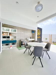 a dining room with a table and chairs at Rosella Chalet in Qurayyah