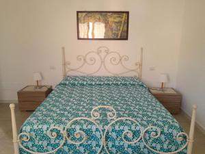 a bedroom with a bed with a blue and white bedspread at 2 La fisarmonica del Conero in Castelfidardo