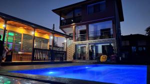 a house with a swimming pool in front of a house at Запряновата къща in Kŭrdzhali
