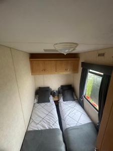 a small room with two beds in a caravan at 8 berth static caravan coral beach ingoldmells in Ingoldmells