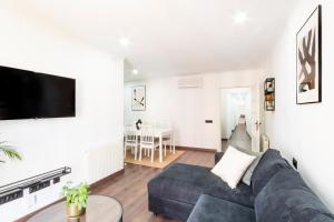 a living room with a couch and a table at Design apartment plaça La font in Tarragona