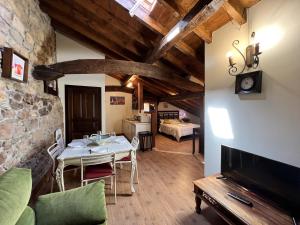 a dining room with a table and a tv in a room at Mirador de Lanchares in Lanchares