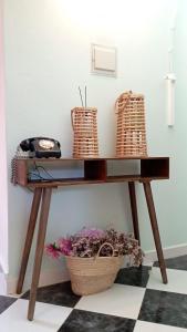 a console table with baskets and flowers on it at Zawaiaroom in Lagos