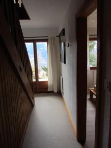 a hallway with a door and a window in a room at Le Refuge in Vérossaz
