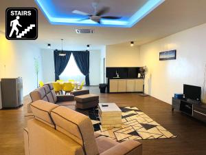 a living room with a couch and a ceiling fan at Hard Rock VIP Guest House in Mersing