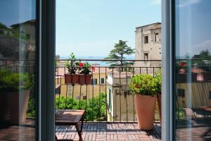 a view of a balcony with potted plants at Riflessi DaMare Room & Apartment in Salerno