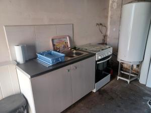 a small kitchen with a sink and a stove at La Forge in Sore