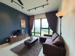a living room with a couch and a tv at Southkey Mosaic Mid Valley Johor Bahru in Johor Bahru