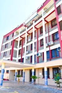 a large building with red and white at Divine Homes Resort Kisumu in Kisumu