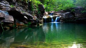 a waterfall in the middle of a pool of water at Can Manén in Camprodon