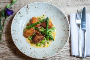 a plate of food with green beans and meat at The Canford in Poole