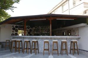 a bar with stools in front of a building at Atlantic Complex Ravda in Ravda