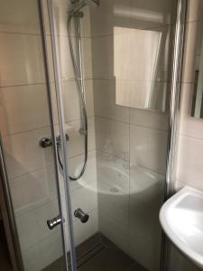 a shower with a glass door next to a sink at FeWo Nürnberg City in Nuremberg