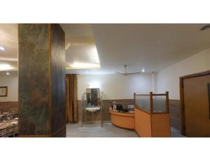 a room with a boat and a table in it at Vishal Hotel, Katra in Katra