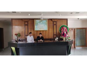 two men sitting at a bar in a room at Vishal Hotel, Katra in Katra