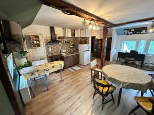 a kitchen and living room with a table and chairs at Mansarda veche in Sinaia