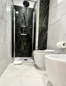 a bathroom with a shower and a toilet and a sink at Perle di Sicilia in Milazzo +13 photos