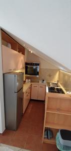 a kitchen with a stainless steel refrigerator and a sink at RITA - Charming 2-Bedroom Apartment with sea view, Slano in Slano