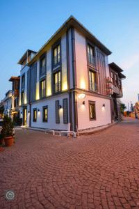 a building on a brick street with a cobblestone road at Violin Hotel Sultanahmet in Istanbul