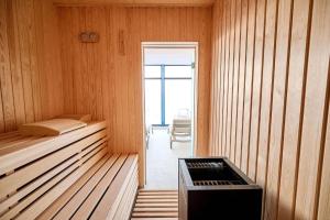 a room with a bed in a wooden room at Aqua Infinity- Pool & SPA Resort in Mamaia Nord +16 photos