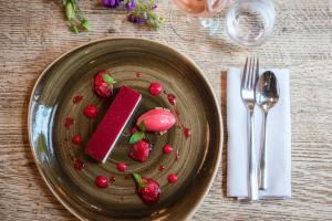 a plate of food with strawberries on a table at The Canford in Poole