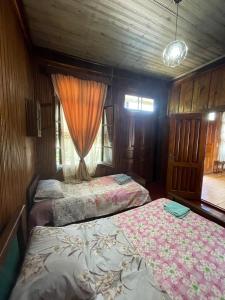 a bedroom with two beds and a window at Martvili Guest House OASIS in Martvili